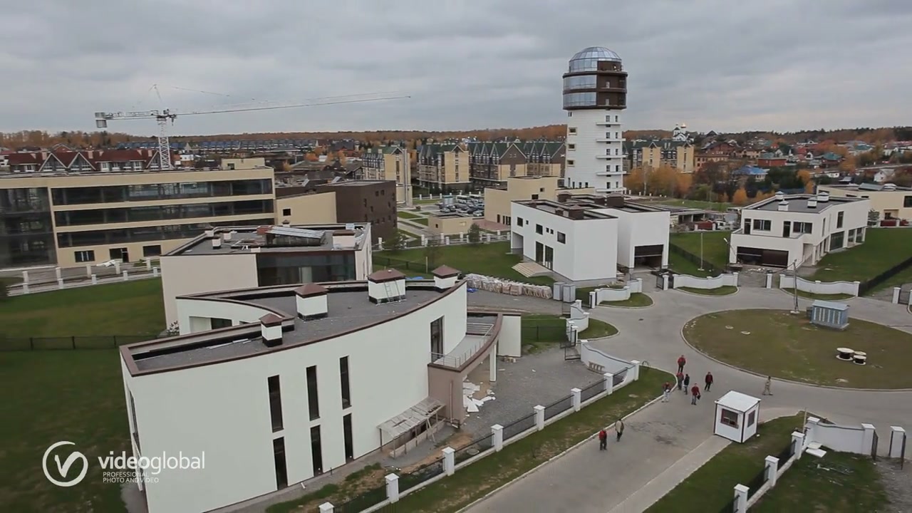панорама посёлка с архитектурной башней-обсерваторией и группой жителей у площади